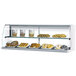 A Turbo Air white display case with a variety of pastries on a shelf.