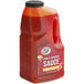 A plastic jug of Sauce Craft Honey Sriracha sauce.