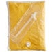 A yellow plastic bag of Ortega Nacho Cheese Sauce with a white plastic tube inside.
