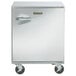 A stainless steel Traulsen undercounter freezer with a handle on wheels.