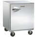 A Traulsen stainless steel undercounter freezer with wheels and a right hinged door.
