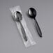 Two Solo Impress heavy weight black plastic soup spoons in plastic packaging.