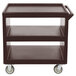 A dark brown Cambro plastic service cart with three shelves and wheels.