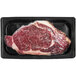 A TenderBison bison ribeye steak in a plastic container.