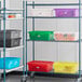 A white storage rack with several red Vigor bus tubs on it.