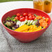 A red GET Red Sensation melamine bowl filled with vegetables and greens.