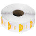A roll of white paper with yellow and orange Noble Products Tuesday food labeling stickers.