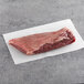 A TenderBison bison flat iron steak on a white surface.