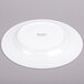 A white Arcoroc porcelain plate with a white rim.