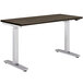 A HON Coze height-adjustable desk with a walnut top and silver legs.