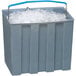 A gray Follett ice storage bin with a blue ice cart handle full of ice.