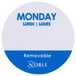 A circular white and blue Noble Products label with the word "Monday" in blue.