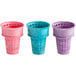 A group of JOY cake cones in different colors: blue, pink, and purple.