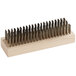 A Texas Brush stainless steel grill brush with a wooden handle.