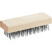 A Texas Brush flat wire grill brush with a wooden handle and metal bristles.