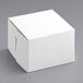 A white Baker's Mark cake box with a lid on a gray background.