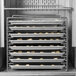 A Delfield tray rack filled with trays of food in an oven.