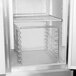 A Delfield stainless steel tray rack in a refrigerator.
