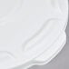 A close-up of a white Rubbermaid lid with a handle.