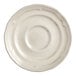 An Acopa Condesa warm gray porcelain saucer with a scalloped edge.