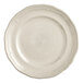 A white Acopa porcelain plate with a scalloped and wide rim.