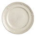 An Acopa Condesa warm gray porcelain plate with a scalloped rim.