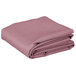 A folded pink rectangular Intedge table cover.