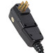 A black electrical plug with gold prongs.