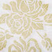 A white and gold floral patterned Hoffmaster linen-like dinner napkin.