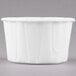 A Solo white paper souffle cup on a gray background.