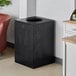 A black rectangular Lancaster Table & Seating decorative waste receptacle with a hole in the middle.
