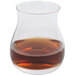 A Stolzle Canadian Whiskey Glass filled with brown liquid.