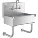 A stainless steel Regency utility hand sink with a wall mounted faucet.