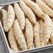 A tray of uncooked Upper Crust Deluxe Donut Croissant Dough sticks.