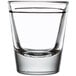 A Libbey shot glass filled with clear liquid on a white background.