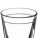 A close up of a Libbey shot glass with a silver rim.