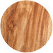 A close up of a wood surface on a round Enjay cake board with a brown finish.