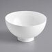 A white Choice plastic mini bowl on a gray surface.