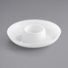 A white plastic mini circular dip tray with a hole in the middle.