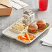 A World Centric compostable fiber tray with burgers, fries, and a drink on it.
