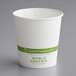 A World Centric white paper hot cup with green text.