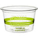 A clear plastic World Centric portion cup with a green compostable label.