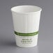 A World Centric white compostable paper hot cup with green text.