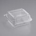 A World Centric clear compostable PLA hinged clamshell container with a lid.