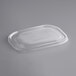 A World Centric clear plastic flat lid on a gray surface.