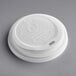 A white World Centric plastic hot cup travel lid with text on it.
