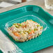 A plastic tray with a World Centric clear rectangular deli container of rice and vegetables.