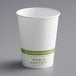 A white World Centric compostable paper hot cup with green text.