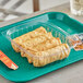 World Centric rectangular clear PLA deli container filled with fried chicken rolls on a tray.