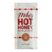 A white Mike's Hot Honey packet with red text on a counter.
